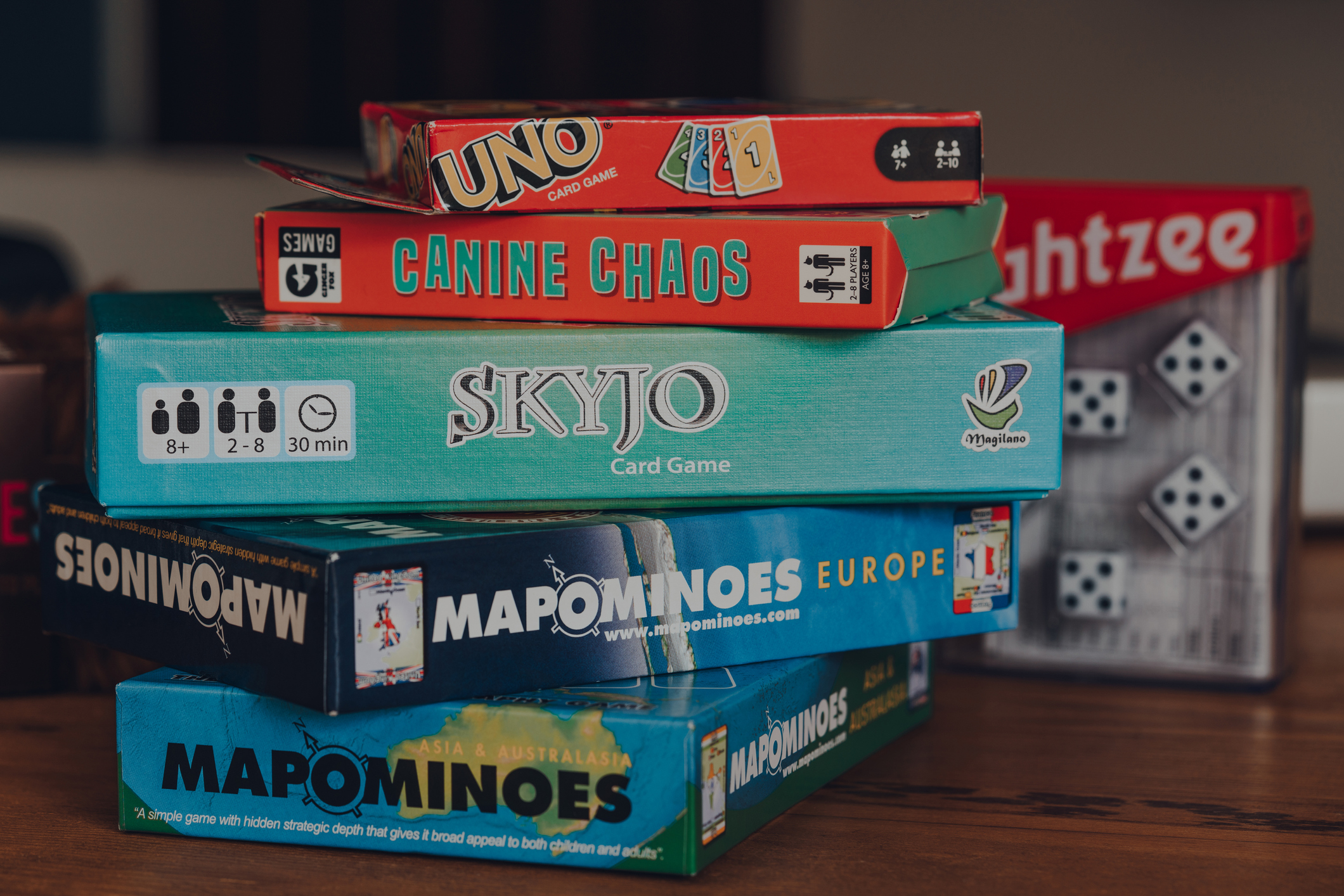 Stack of modern and classing board games on a table.
